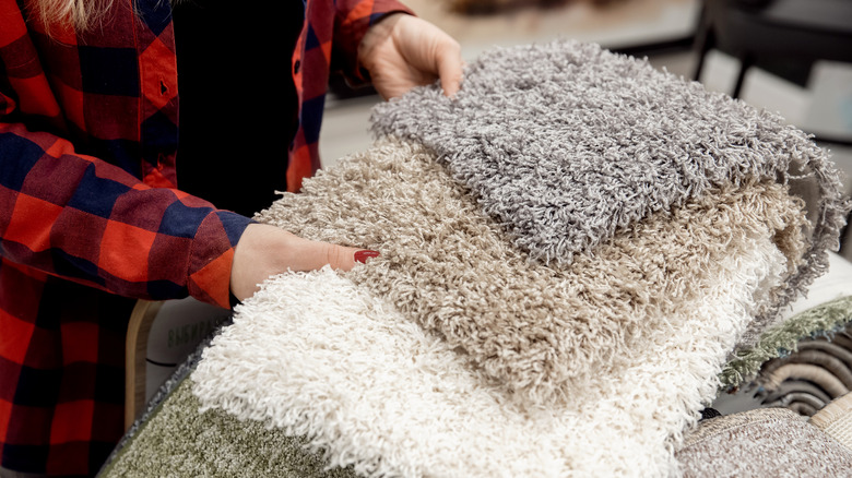 person looking at rugs in store