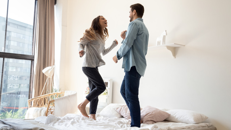 couple standing on mattress