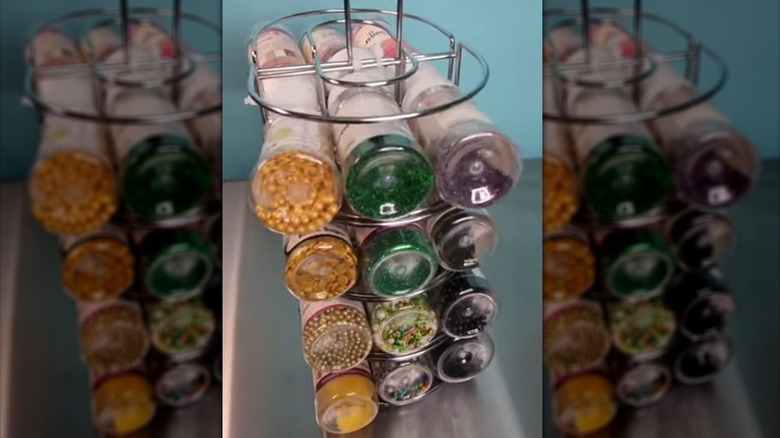 Spice rack made from Dollar Tree napkin holder and paper towel holder holding sprinkles
