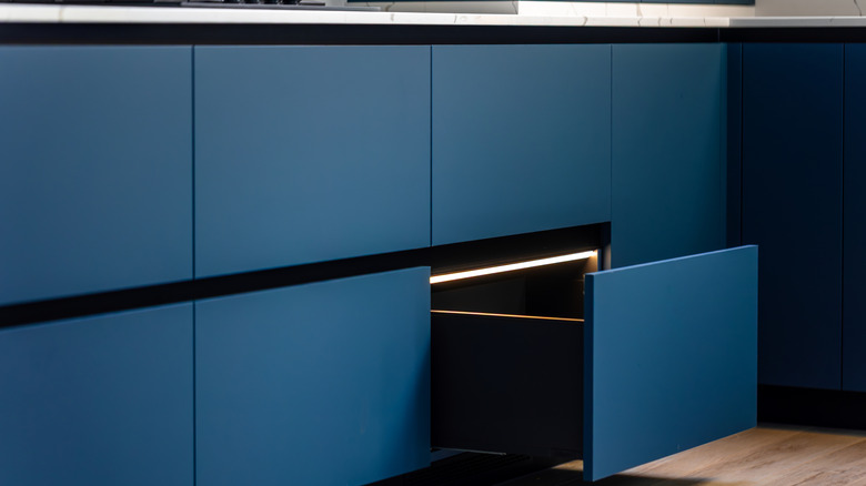 Blue handleless drawers in kitchen