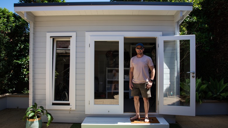 Man standing on shed porch