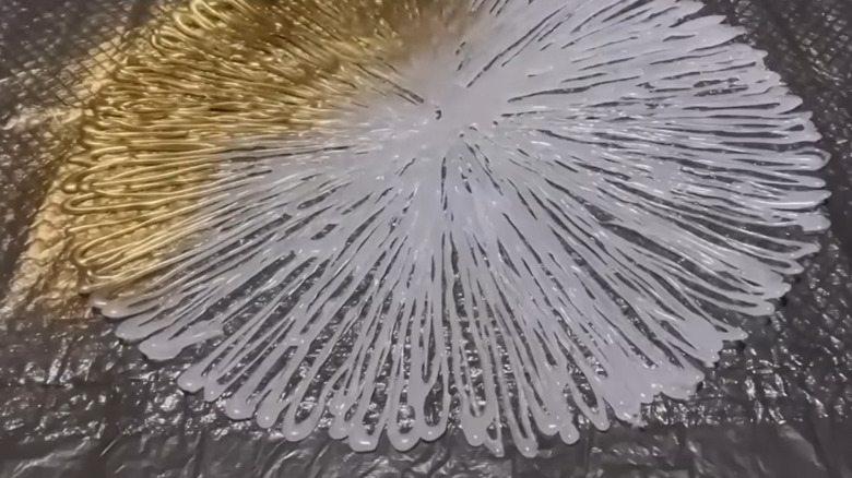 hot glue design being spray painted gold
