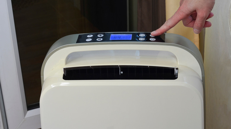 Person turning on dehumidifier