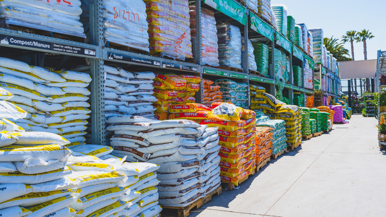 Inventory of stacked soil bags in outdoor garden store