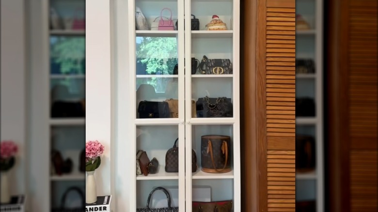 IKEA BILLY cabinet with glass-front doors turned into purse storage and display