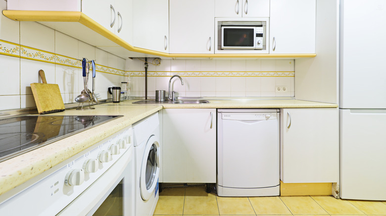 White and yellow L-shaped kitchen
