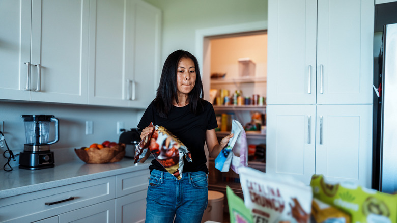 Person going through a pantry and organizing it