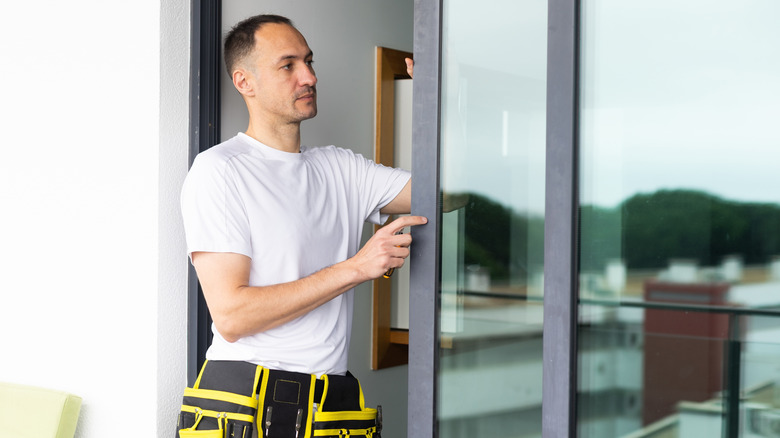 Man installing sliding glass patio doors