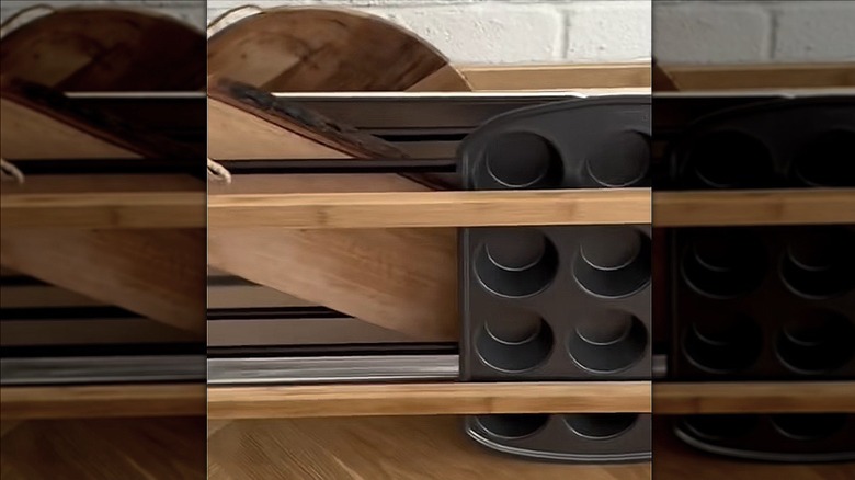 Baking trays and cutting boards slotted inside of a shoe rack