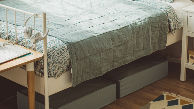 two fabric containers under a bed