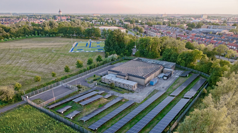 An aerial view of a solar-powered data center adjacent to residential homes