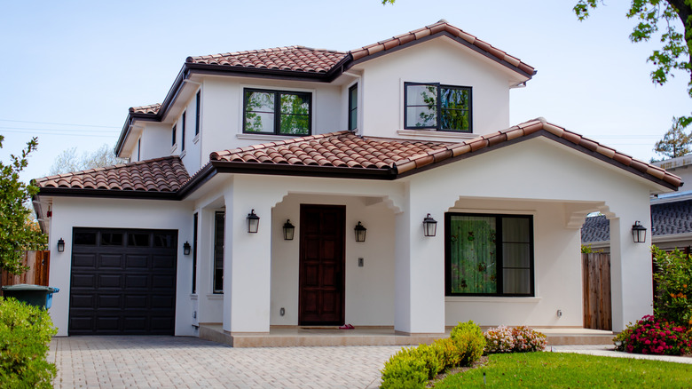 The exterior view of a home with a visible front door and garage