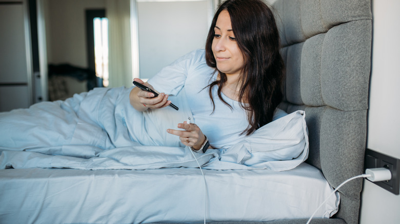 Woman on phone in bed