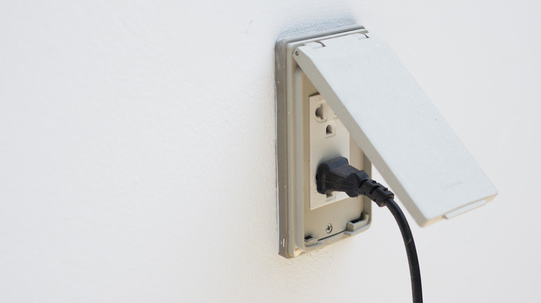 Exterior outlet on a white wall of a home