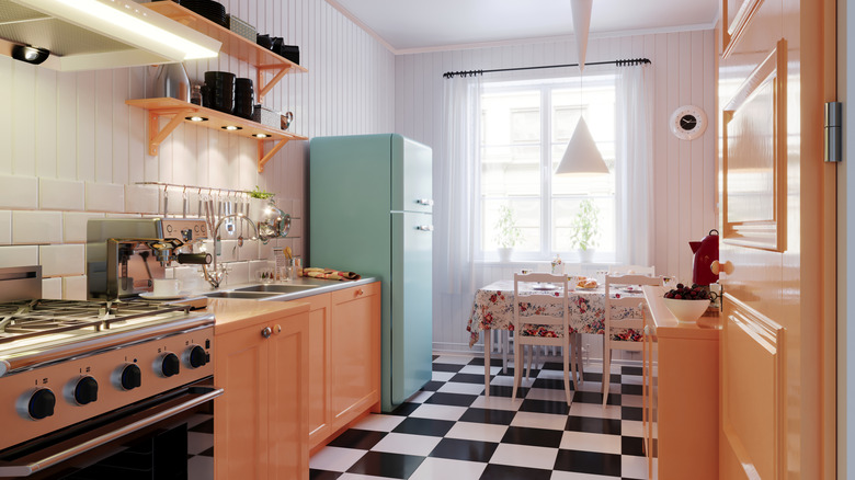 Kitchen with blue retro refrigerator and pink cabinets