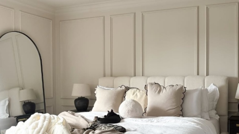 Cozy bedroom with warm, soft stone walls using Farrow & Ball's Skimming Stone