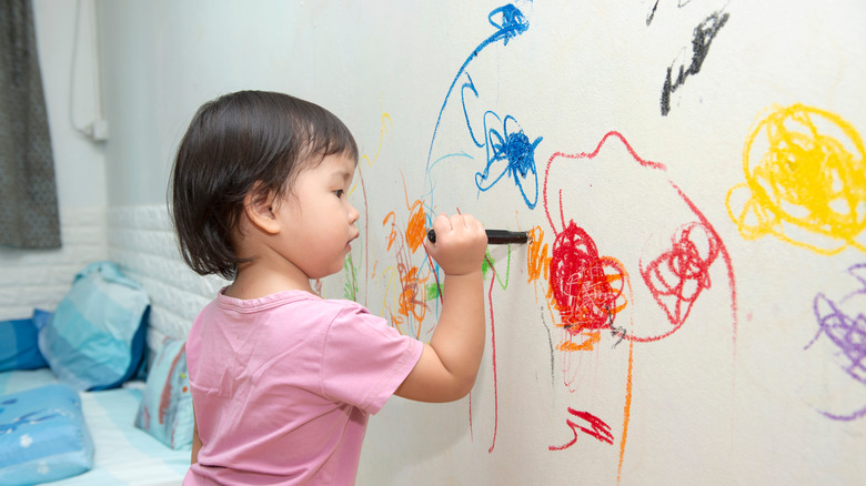 kid drawing on wall 