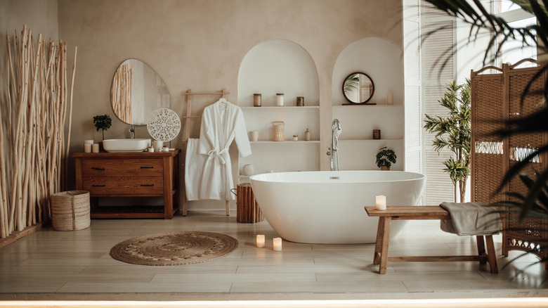 Spa-like bathroom decorated with wood accents and candles