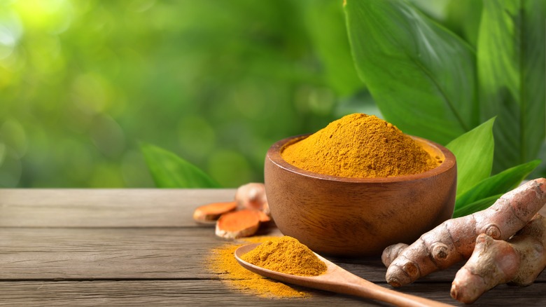 Turmeric powder in wood bowl