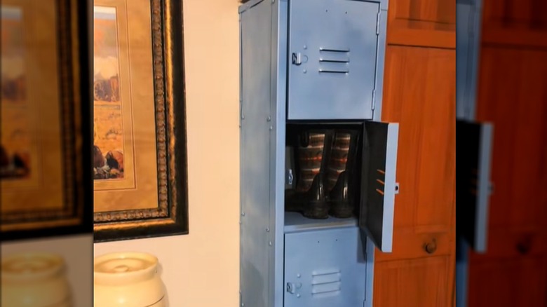 A repurposed gym locker holds a pair of boots as a home shoe organizer.