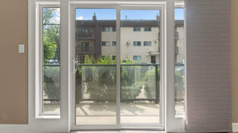A white sliding glass door leading outside