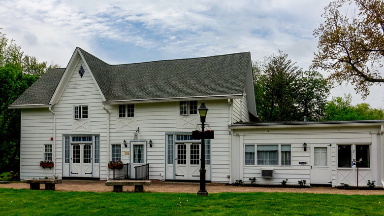 A modernized carriage house beside a white home