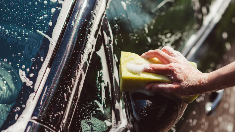 washing a car with a sponge