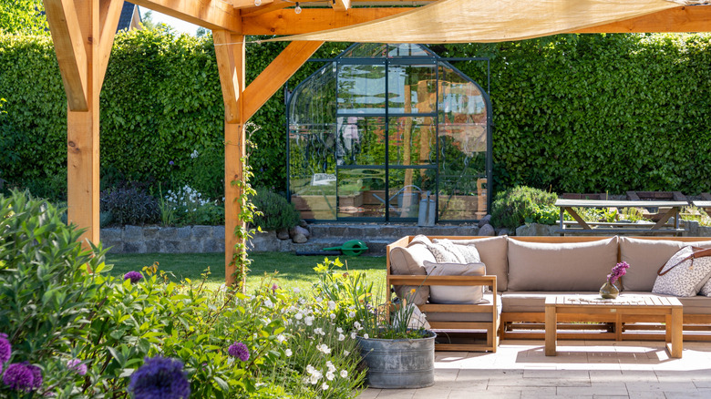 A set of outdoor furniture under a pergola