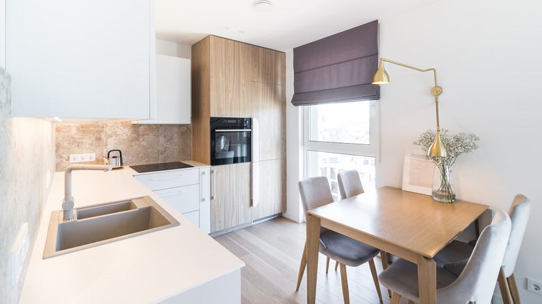 A modern kitchen with the refrigerator and oven integrated into the cabinets.