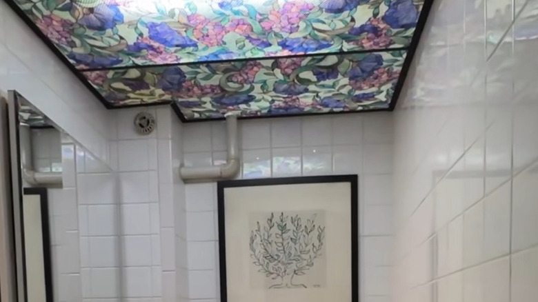 a stained glass window film on diffuser panels in a bathroom