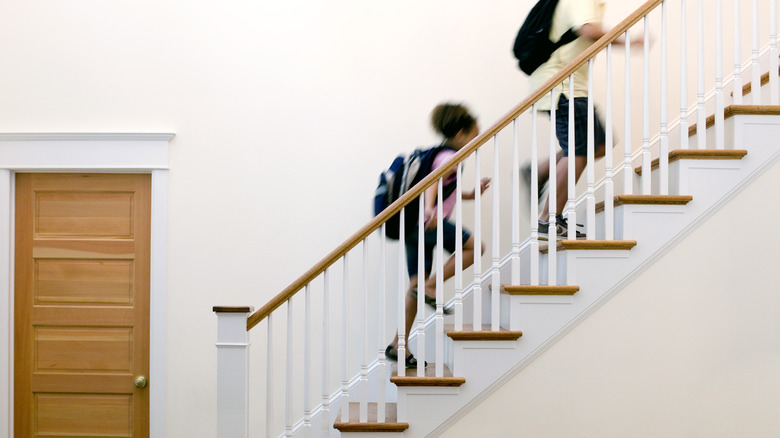 Children walking up a staircase