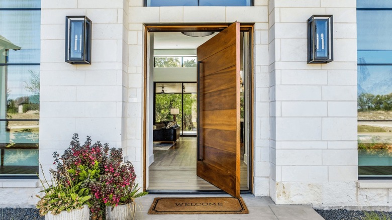 An inside view of a woodenpivot front door