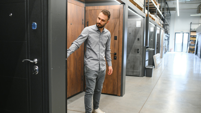 Man looking at door samples at a showroom