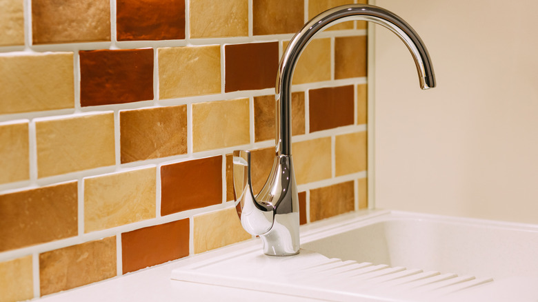 Polished nickel faucet in kitchen sink