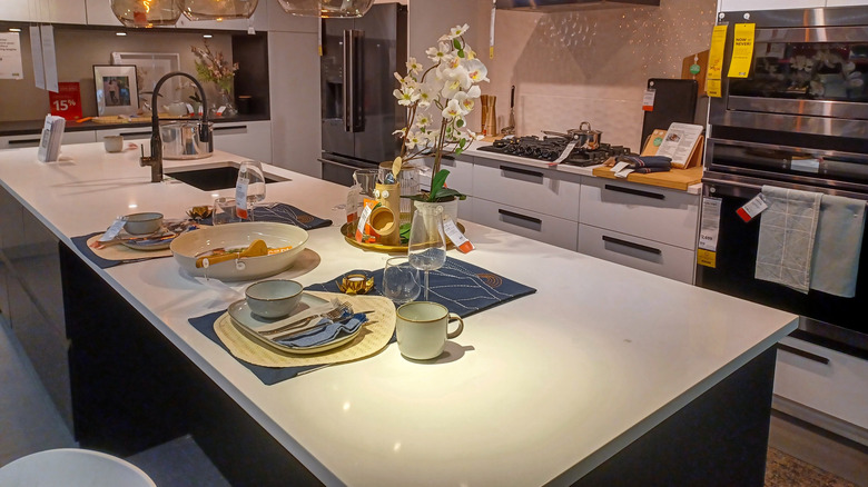 A kitchen island in a showroom showing different zones