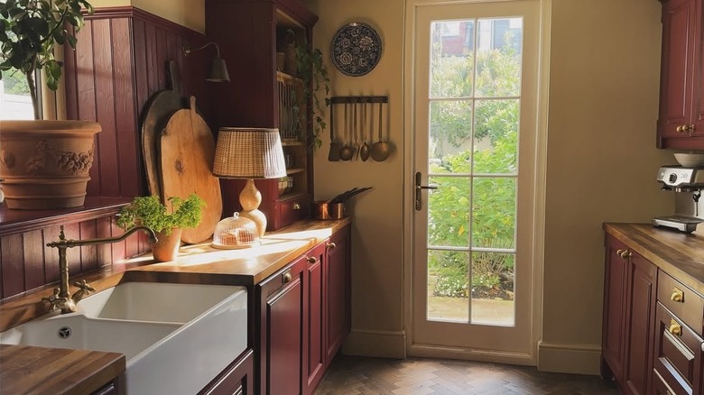 Picture of merlot-colored kitchn with bronze and natural wood accents