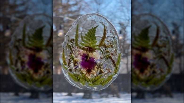 A DIY sun-catcher hanging on a window.