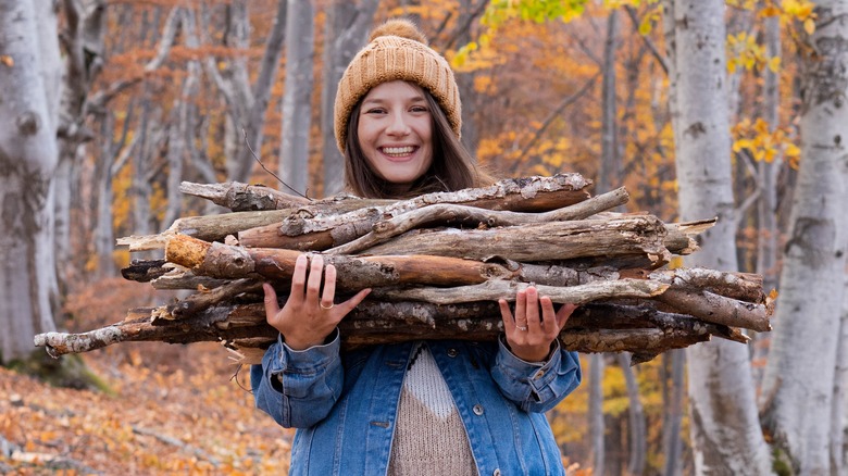 Woman carrying tree branches