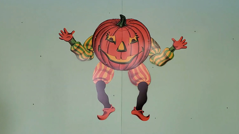 a spooky pumpkin headed halloween decoration