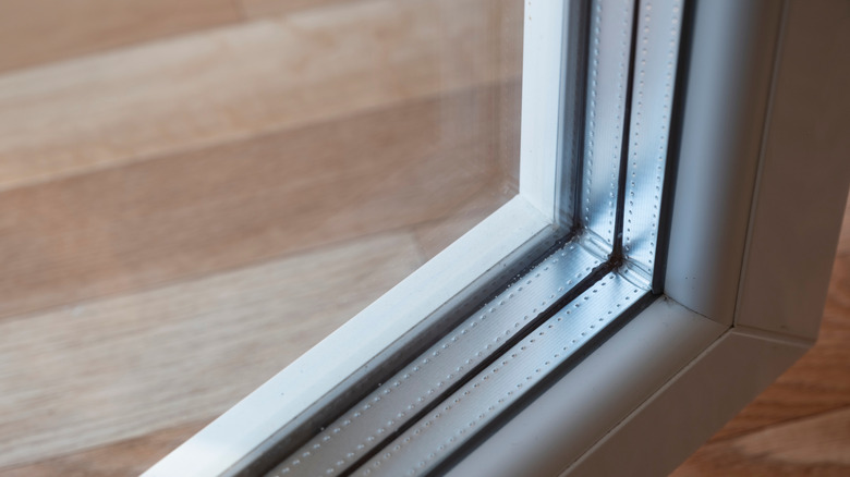Close-up shot of a triple paned window above wood floor