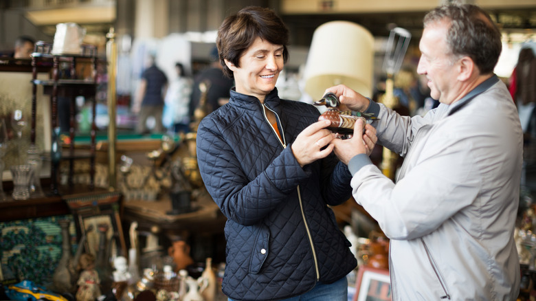 A couple shopping for antiques at a flea market.