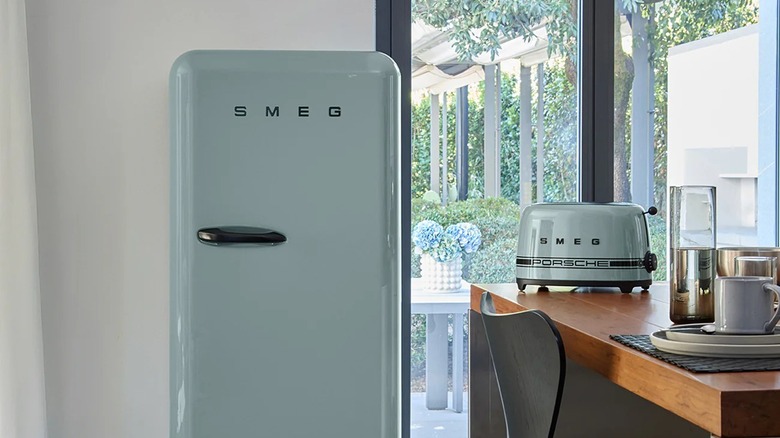 A mint green vintage-style SMEG fridge in a modern kitchen