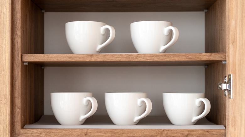 White coffee mugs on shelves.
