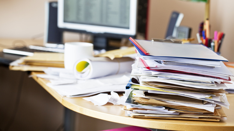 stack of messy files on desk