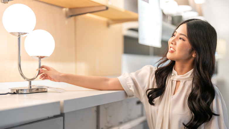 Woman looking at a lighting fixture