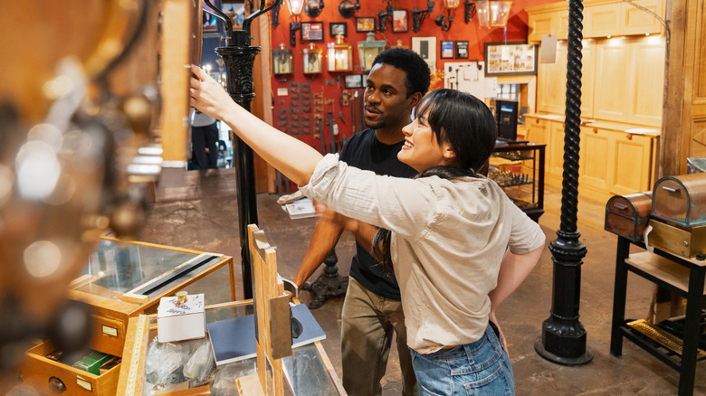 A couple browsing items at an antique shop