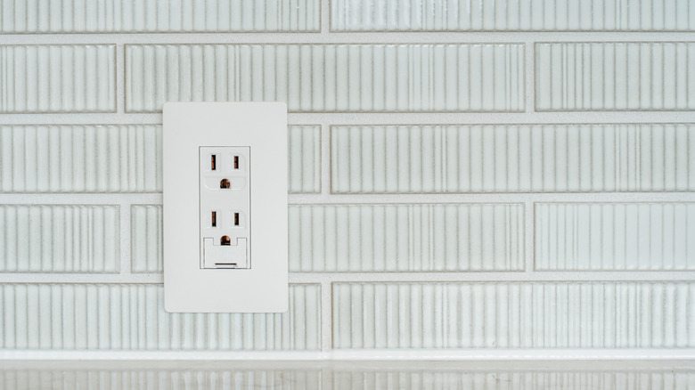 Outlet on a white brick wall