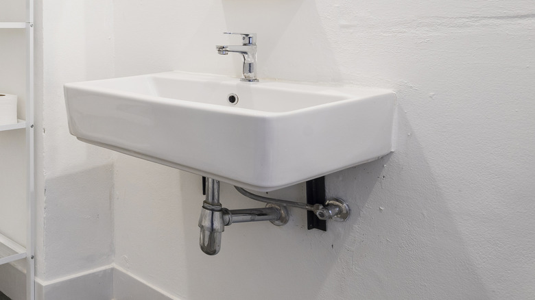 A bathroom sink with nothing underneath