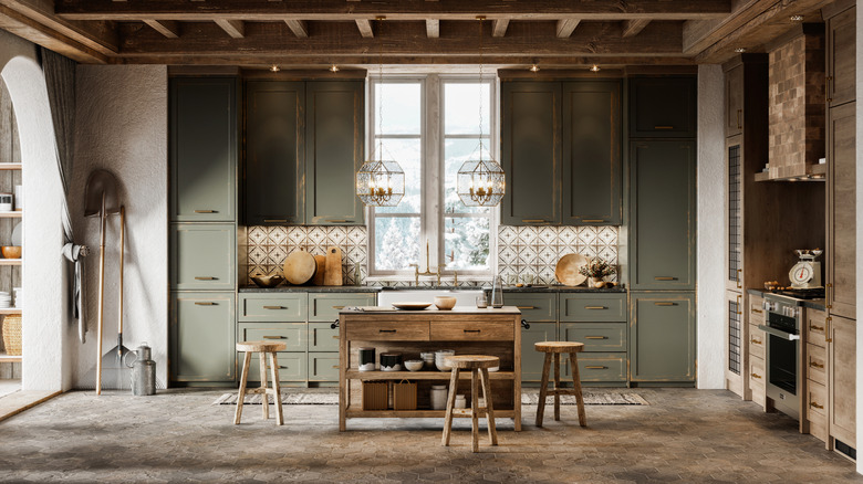 Contemporary rustic kitchen with elegant touches, muted olive green cabinets, and dark countertops