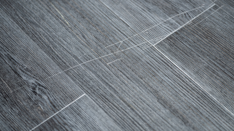 scratches on gray-colored flooring